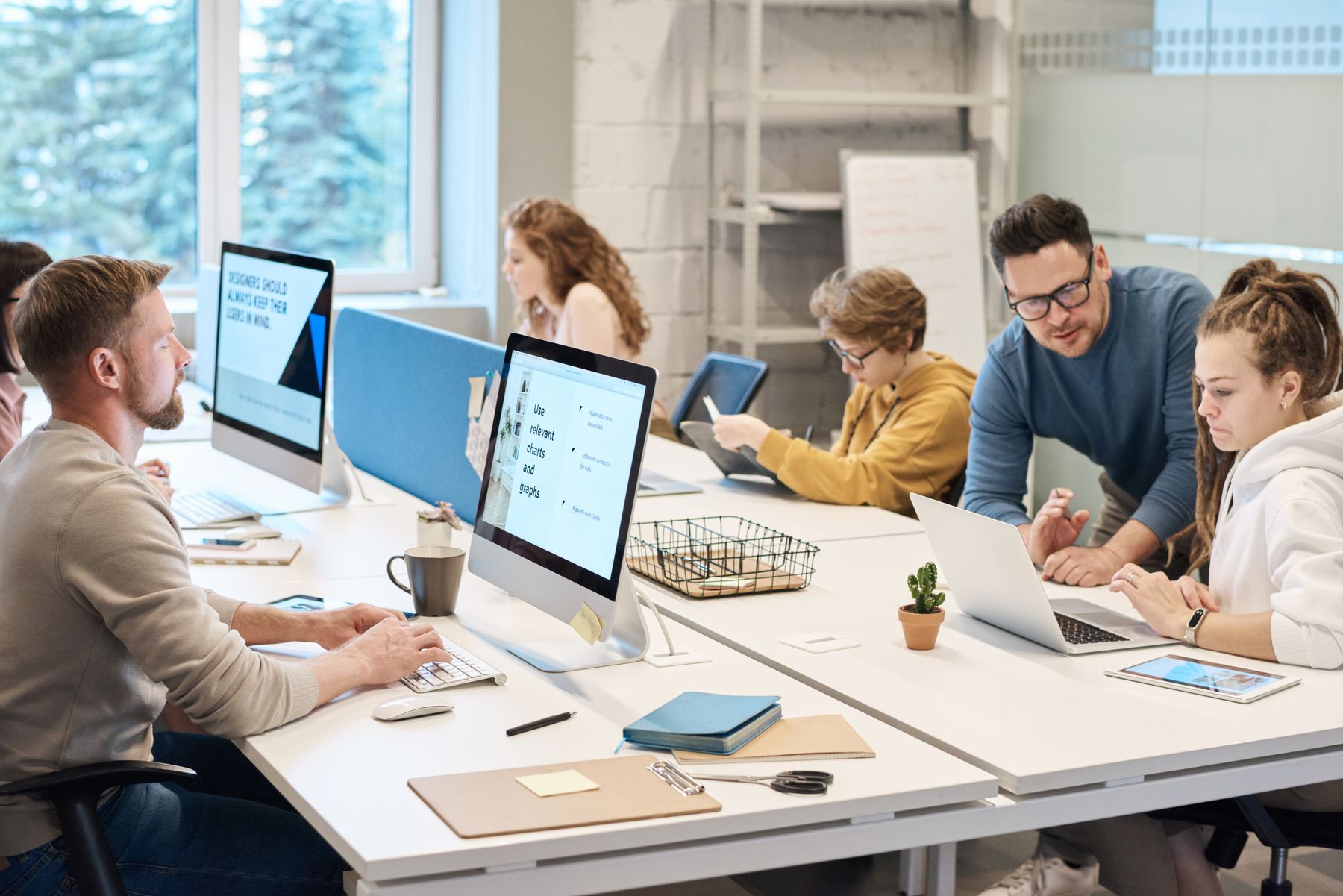 People working together at computers. Stock photograph, not SAINT employees.